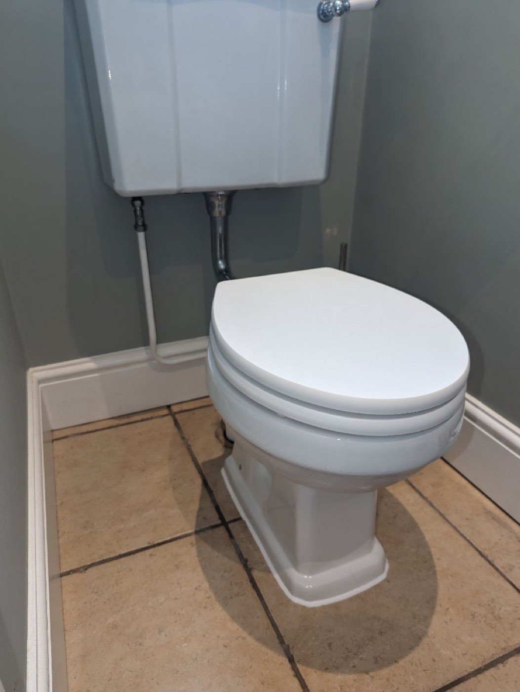 The same corner with a new toilet fitted and the pipework tidied