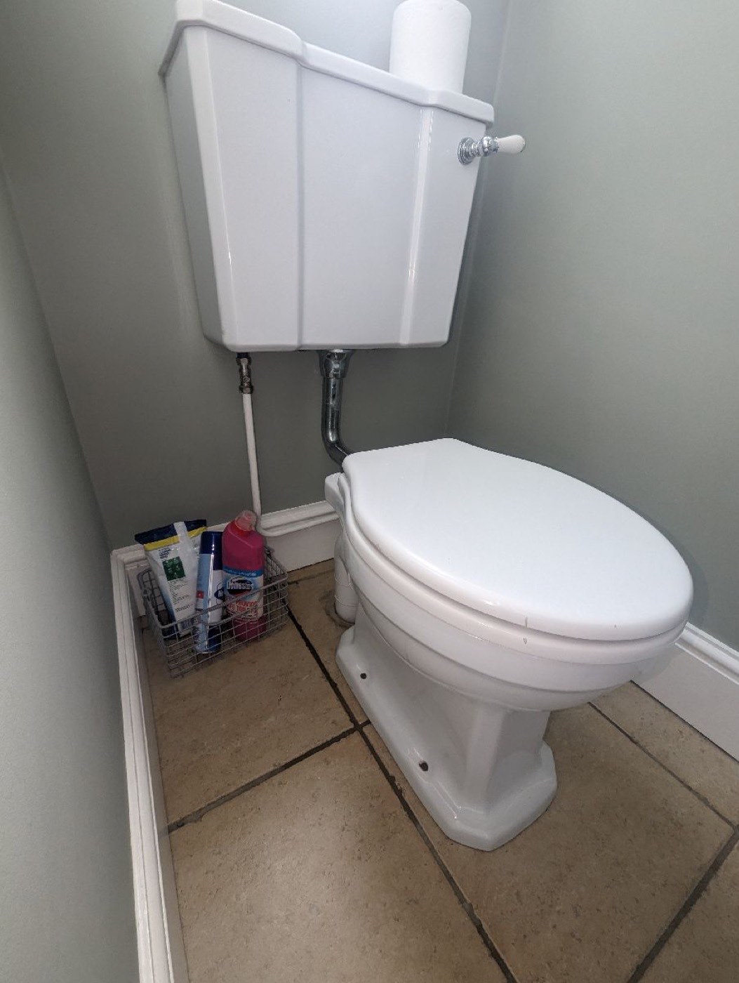 Tired close-coupled toilet before removal